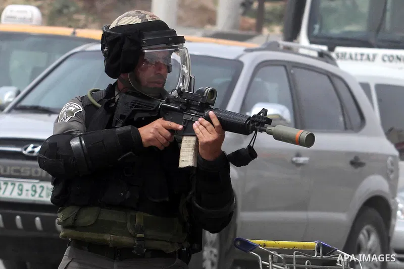 Israeli soldiers take position during clashes with Palestinian protestors at the Qalandia checkpoint, in the occupied West Bank on March 30, 2013. Land Day commemorates the death of six Arab Israeli protesters at the han...