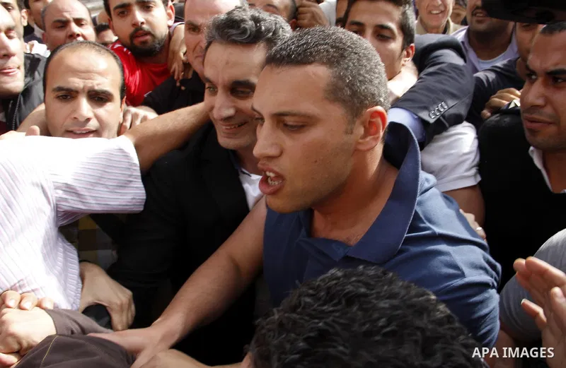 Egyptian artist Bassem Yousef walks out the High Court in Cairo on March 31, 2013. Bassem Youssef, the Arab world's 'Jon Stewart', had been issued an arrest warrant and compulsory summons by the prosecutor-general. The c...