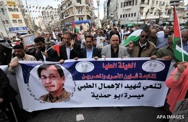 Palestinians take part a protest in the West Bank city of Ramallah, 02 April 2013, after the news of the death of Maysara Abu Hamdiyeh in the Israeli Soroka hospital. Reports state that Maysara Abu Hamdiyeh died after be...
