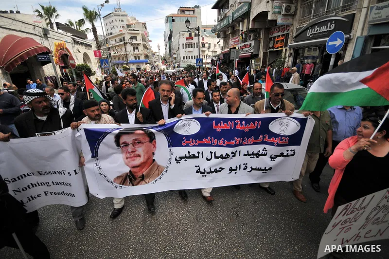 Palestinians take part a protest in the West Bank city of Ramallah, 02 April 2013, after the news of the death of Maysara Abu Hamdiyeh in the Israeli Soroka hospital. Reports state that Maysara Abu Hamdiyeh died after be...