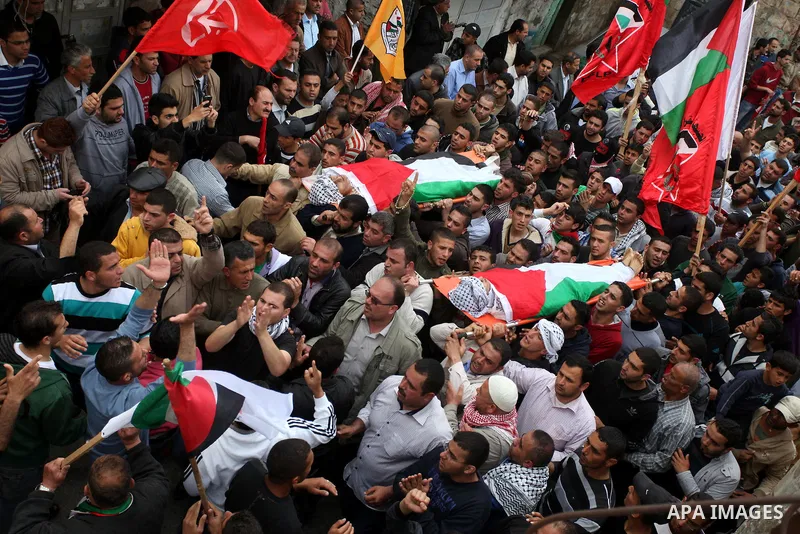 Palestinian mourners carry the bodies of Amer Nassar and Naji Balbisi during their funeral in Anabta village near the West Bank city of Tulkarem, 04 April 2013. Israeli soldiers shot dead two Palestinian protesters in th...