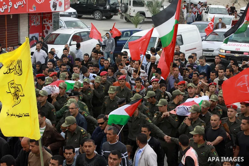 Palestinian police officers carry the bodies of Amer Nassar and Naji Balbisi during their funeral in Anabta village near the West Bank city of Tulkarem, 04 April 2013. Israeli soldiers shot dead two Palestinian protester...