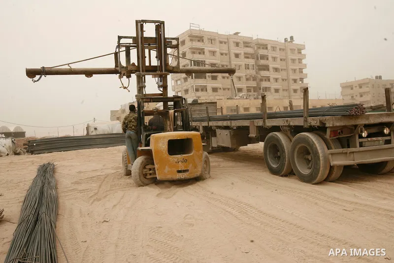 A forklift truck is seen carries ribbed construction iron bars following smuggled through a smuggling tunnel between the Hamas-ruled Gaza Strip and Egypt in the southern Gaza Strip city of Rafah on April 4, 2013. The Egy...