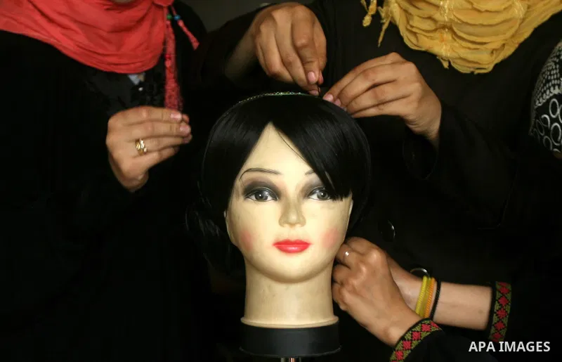 Palestinian girls attend lesson of the hairdressing beauty at The Adam Training Academy, in Rafah town in the southern Gaza Strip on Apr. 06, 2013. Photo by Eyad Al Baba