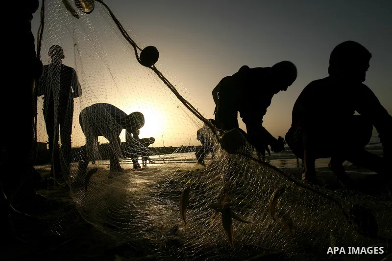 Palestinian men fishing on the beach of Gaza city on Apr. 07, 2013. An Israeli military spokesman announced on March 21, that the Israeli military will again reduce the permitted fishing range in the Gaza Strip from six...
