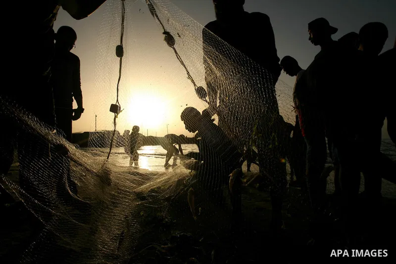 Palestinian men fishing on the beach of Gaza city on Apr. 07, 2013. An Israeli military spokesman announced on March 21, that the Israeli military will again reduce the permitted fishing range in the Gaza Strip from six...