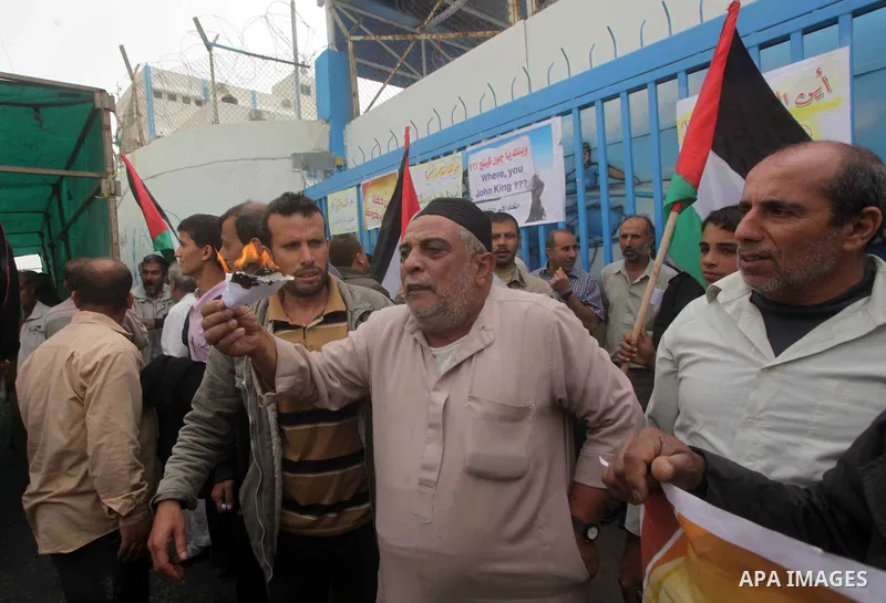 Palestinians try to prevent a refugee from setting himself on fire during a protest demanding the United Nations Relief and Works Agency (UNRWA) to resume aid for refugees, in front of the UNRWA headquarters in Gaza City...