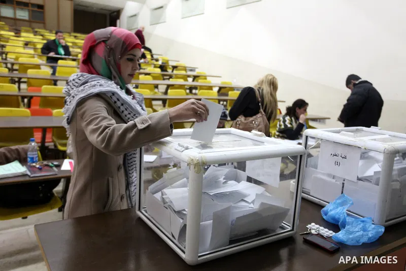 A Palestinian student casts her ballot during the election for the student council at Birzeit University, on the outskirts of the West Bank city of Ramallah on April 10, 2013. The main competitors in the student election...