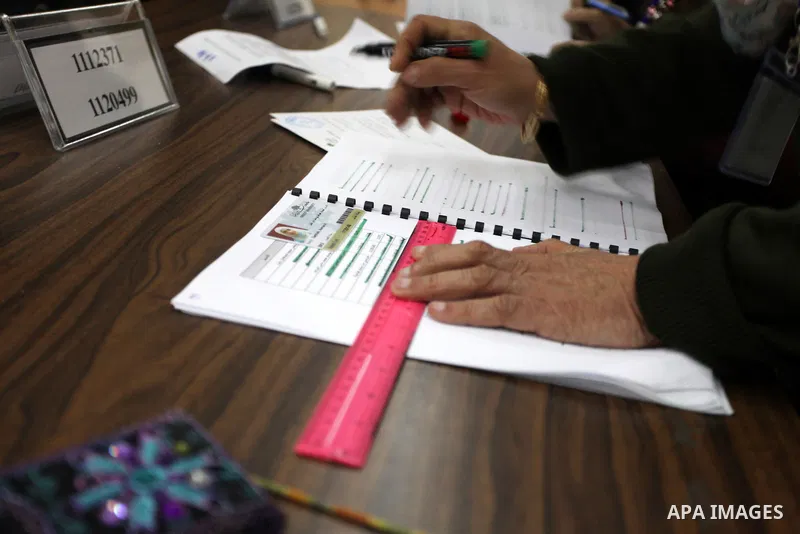 A Polling station official counts ballots during the election for the student council at Birzeit University, on the outskirts of the West Bank city of Ramallah on April 10, 2013. The main competitors in the student elect...