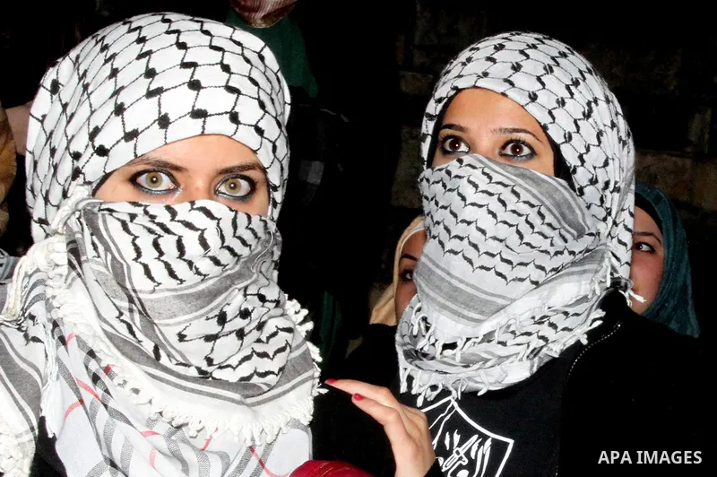 Birtzeit University students loyal to Fatah celebrate their victory over Hamas in the university elections, next to the Birzeit University campus near the West Bank city of Ramallah, on April 10, 2013. Fatah won 23 seats...