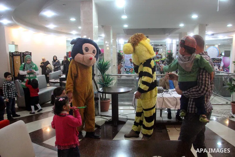 Palestinian children take part in a ceremony organized by "Fosha" a tourism organisation, marking Children's Day, in Gaza city on April 11, 2013. Children's Day is recognized on various days in many places around the wor...