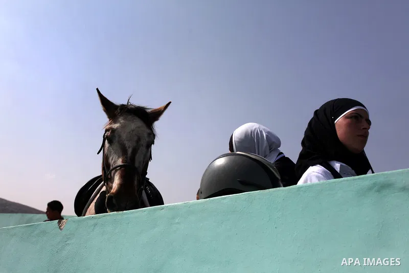 Palestinian jockeys demonstrate their skills as they ride their horses during a participate in the first Spring Festival at Turmus'ayya village near in the West Bank city of Ramallah, on Apr. 13, 2013. Photo by Issam Rim...