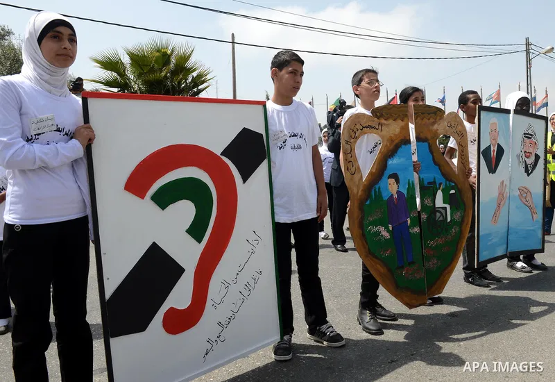 Palestinian children participate in a Carnival children of the State of Palestine, in front of the grave of the late Palestinian leader Yasser Arafat in the West Bank city of Ramallah, on Apr. 13, 2013. Photo by Thaer Ga...