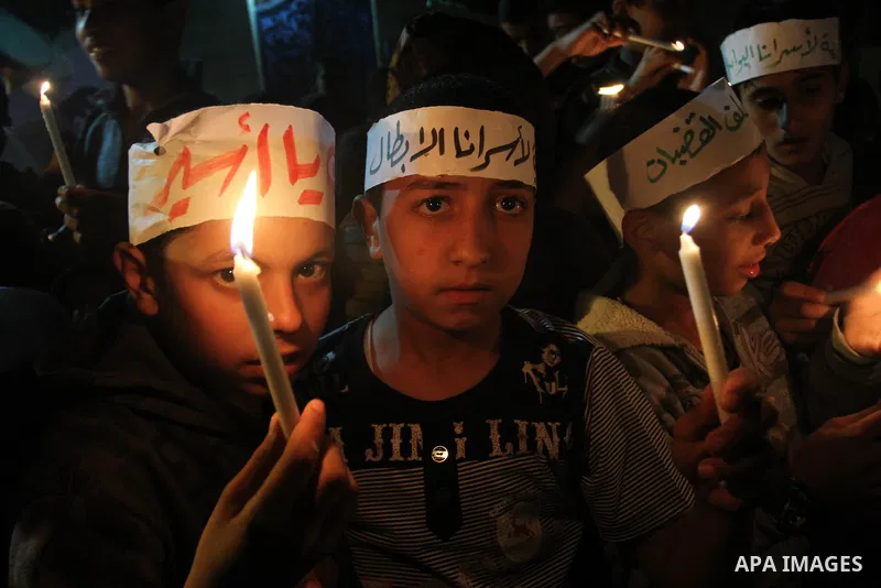 Palestinian children light candles during a rally to show solidarity with Palestinian prisoners inside Israeli jails, in Gaza City April 15, 2013. According to a Palestinian prisoners' association, at least 4900 Palestin...
