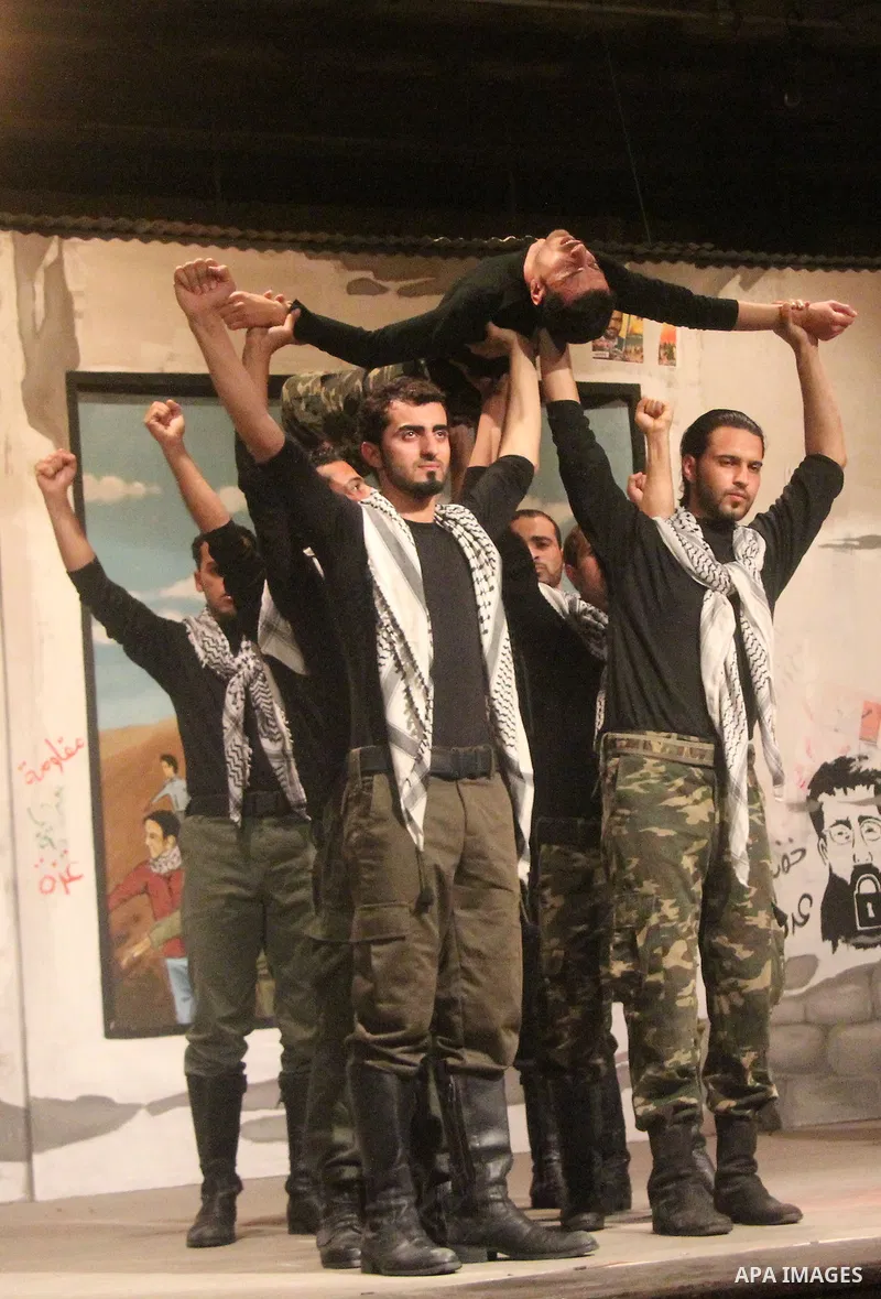 Palestinian artists perform during a ceremony organized by Islamic Jihad movement, to show solidarity with Palestinian prisoners inside Israeli jails, ahead of Palestinian prisoner's day in Gaza city on April 16, 2013. P...