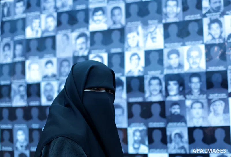 A Palestinian veiled woman poses in front of pictures of leaders that were imprisoned in the Saraya prison, in Central Gaza City, Gaza Strip, 17 April 2013. The facility has now been turned into a memorial center with th...