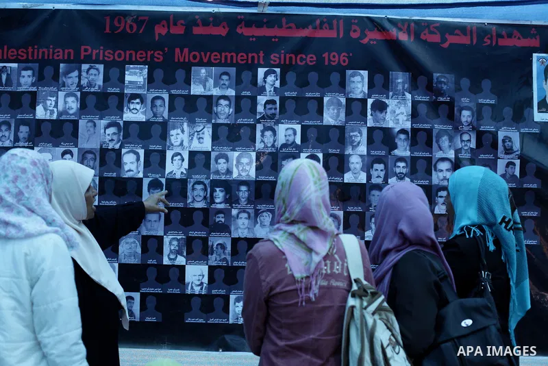Palestinian women look at pictures of leaders that were imprisoned in the Saraya prison, in Central Gaza City, Gaza Strip, 17 April 2013. The facility has now been turned into a memorial center with the help of Hamas and...