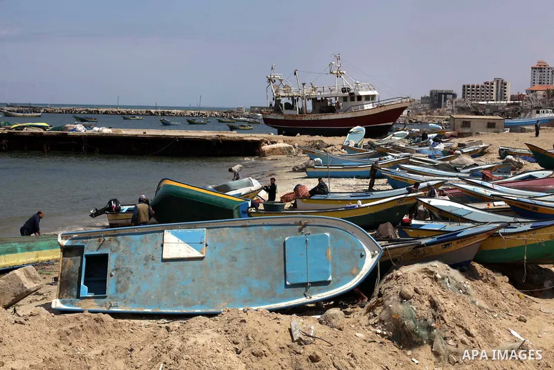 Palestinian workers fix old fishing boats in the west of Gaza city on April 18, 2013. The fishing boats industry flourished in Gaza strip since the Israeli blockade, many of unemployed Palestinians have taken fishing as...