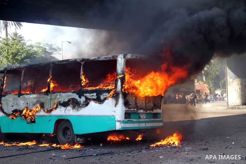 A bus which, according to protesters, belongs to the Muslim Brotherhood burns after anti-president Mohammed Morsi demonstrators set it on fire during clashes near Tahrir Square in Cairo, April 19, 2013. Photo by Tareq Ga...