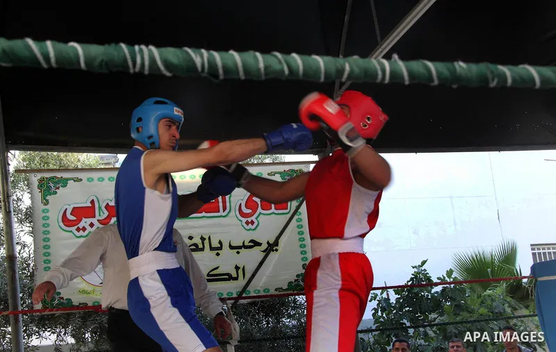 Palestinian boxers exchange blows during the championship of "Loyalty to Palestinian Prisoners" in Gaza city on April 19, 2013. Some of 34 Palestinian boxers participated in championship organised by the Palestinian Fede...