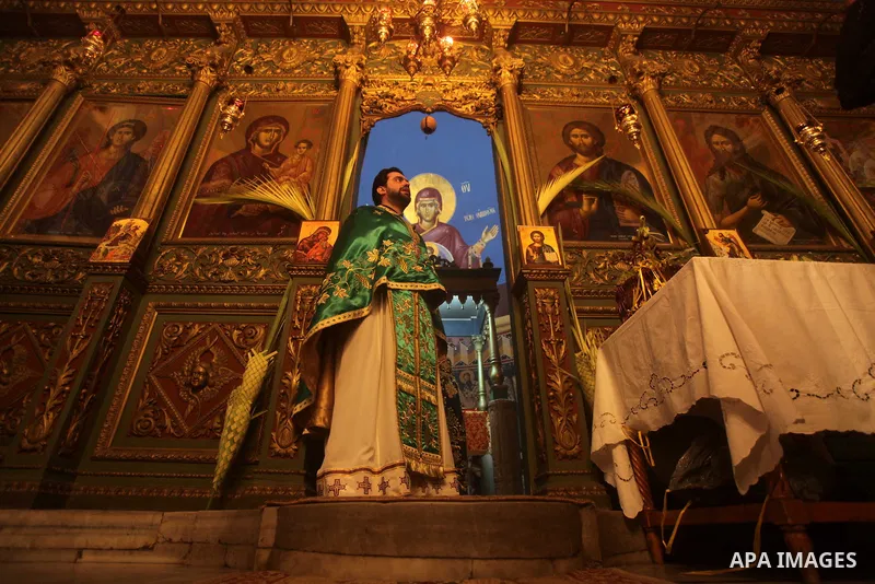 Christians attend Palm Sunday mass at the Saint Porfirios church in Gaza City on April 28, 2013. Photo by Ashraf Amra
