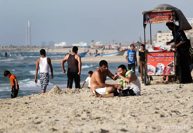 Palestinians enjoy a day at the beach of Gaza city during hot weather on April 28, 2013. Photo by Sameh Rahmi