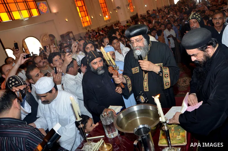 Egyptian Orthodox Christians take part in a mass marking the Palm Sunday on April 28, 2013 in Cairo. Palm Sunday marks the triumphant return of Jesus Christ to Jerusalem when a cheering crowd greeted him waving palm leav...