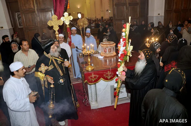 Egyptian Orthodox Christians take part in a mass marking the Palm Sunday on April 28, 2013 in Cairo. Palm Sunday marks the triumphant return of Jesus Christ to Jerusalem when a cheering crowd greeted him waving palm leav...