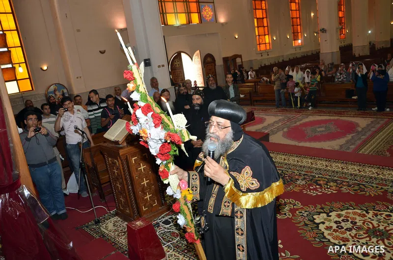 Egyptian Orthodox Christians take part in a mass marking the Palm Sunday on April 28, 2013 in Cairo. Palm Sunday marks the triumphant return of Jesus Christ to Jerusalem when a cheering crowd greeted him waving palm leav...