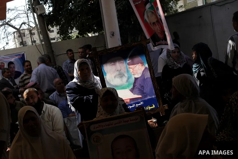 Palestinian women hold pictures of prisoners held in Israeli jails during a protest in front of the Red Cross offices in Gaza city, on Apr. 29, 2013 in solidarity with Palestinian prisoners held by Israel to demand their...
