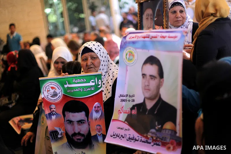 Palestinian women hold pictures of prisoners held in Israeli jails during a protest in front of the Red Cross offices in Gaza city, on Apr. 29, 2013 in solidarity with Palestinian prisoners held by Israel to demand their...