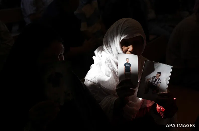 Palestinian women hold pictures of prisoners held in Israeli jails during a protest in front of the Red Cross offices in Gaza city, on Apr. 29, 2013 in solidarity with Palestinian prisoners held by Israel to demand their...