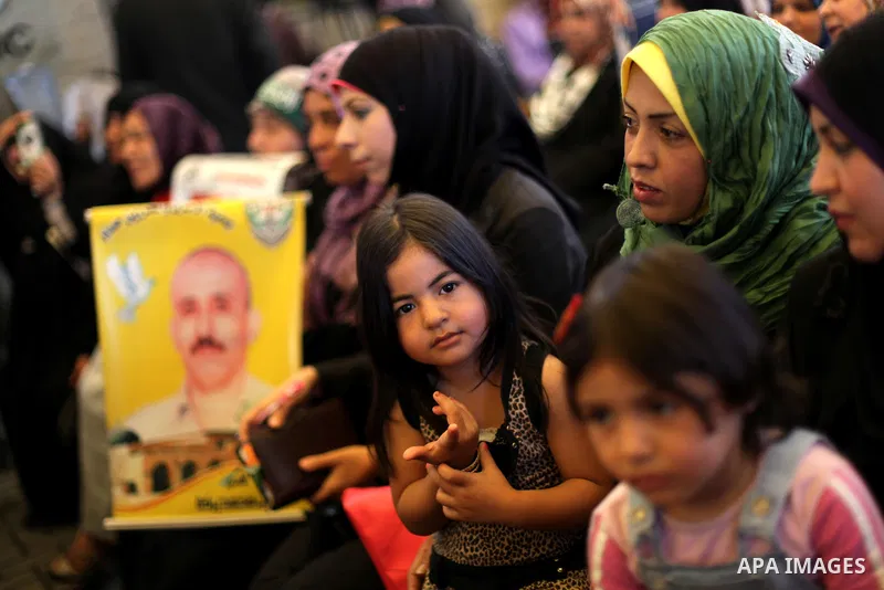 Palestinian women hold pictures of prisoners held in Israeli jails during a protest in front of the Red Cross offices in Gaza city, on Apr. 29, 2013 in solidarity with Palestinian prisoners held by Israel to demand their...