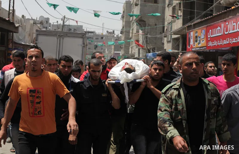 Palestinians mourners carry the body of Haitham Al-Meshal, during his funeral in Gaza City, on April 30, 2013. An Israeli air strike on Gaza City killed one person Palestinian officials said, with Israel saying it target...
