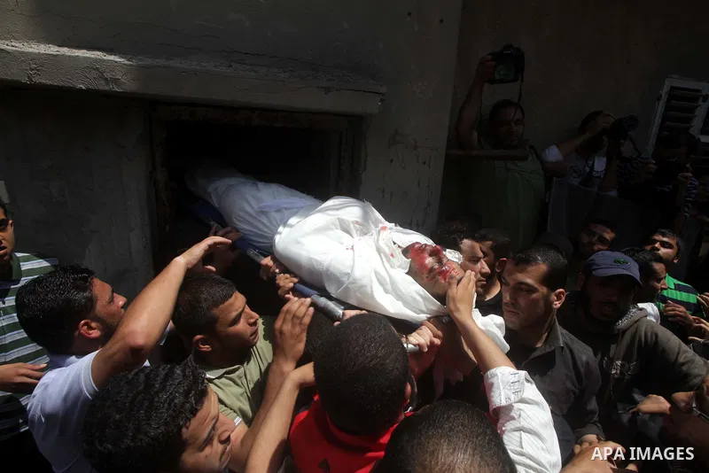 Palestinians mourners carry the body of Haitham Al-Meshal, during his funeral in Gaza City, on April 30, 2013. An Israeli air strike on Gaza City killed one person Palestinian officials said, with Israel saying it target...