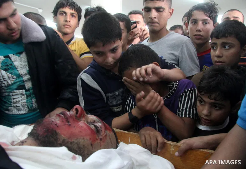 Palestinians gather around the body of Haitham Al-Mes-hal, who relatives said belonged to a militant Jihadist Salafi organisation, during his funeral at a mosque in Gaza City April 30, 2013. Israel on Tuesday launched it...