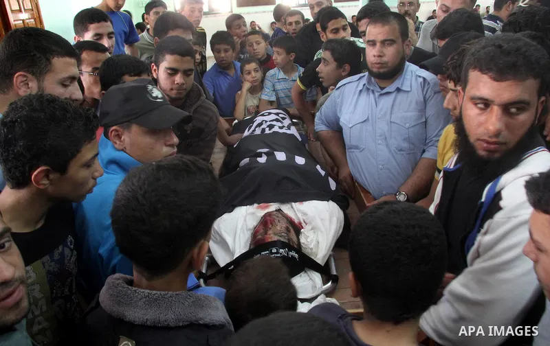 Palestinians gather around the body of Haitham Al-Mes-hal, who relatives said belonged to a militant Jihadist Salafi organisation, during his funeral at a mosque in Gaza City April 30, 2013. Israel on Tuesday launched it...