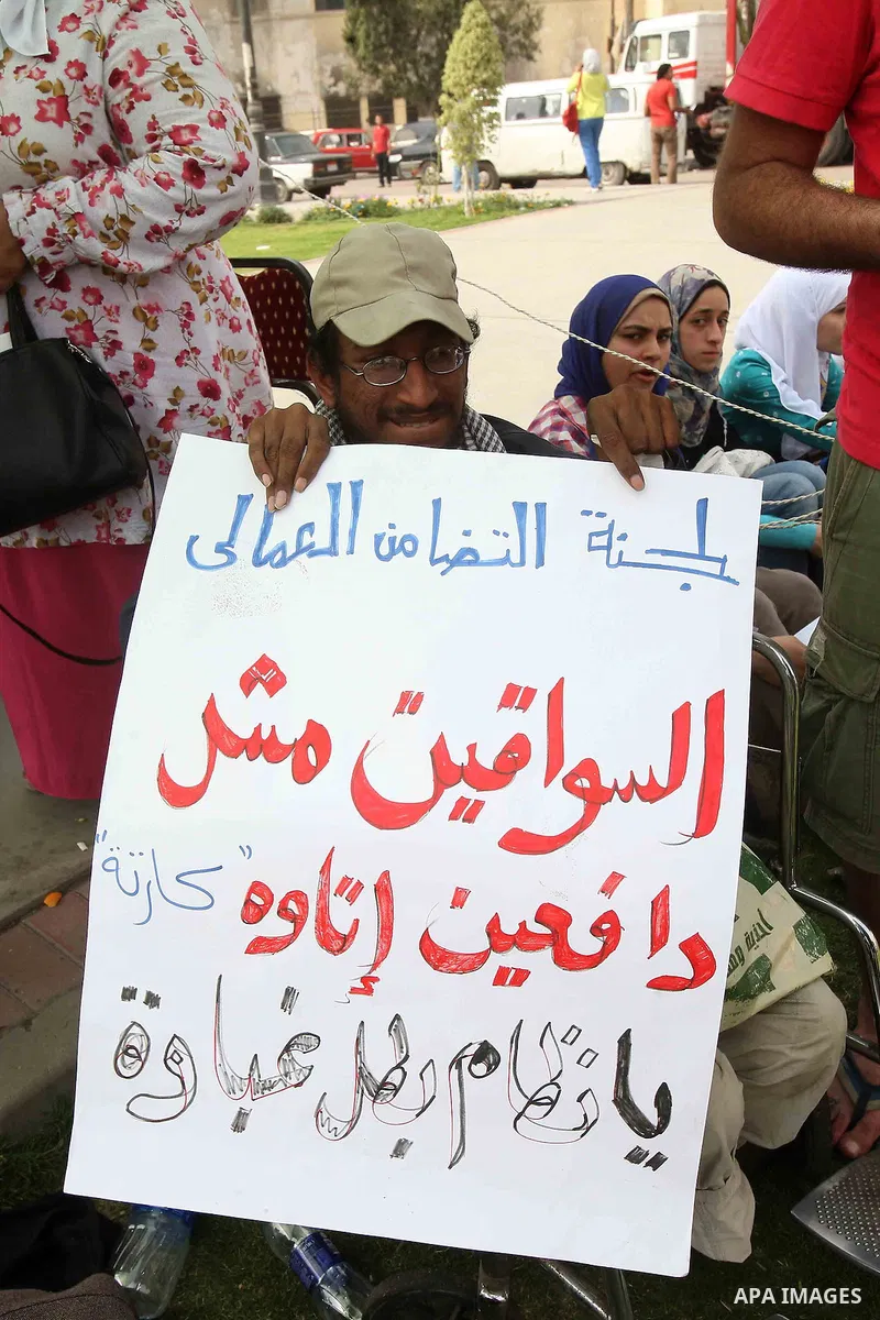 Egyptians hold placards during ceremony marking May Day in Helwan near Cairo, on May 03, 2013. Photo by Tareq Gabas