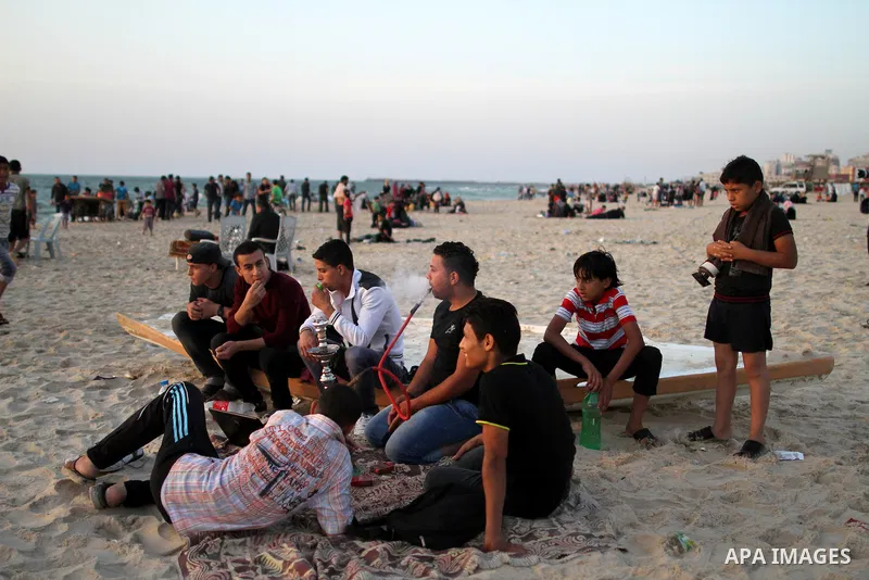 Palestinians enjoy swimming in the sea at Gaza beach during Friday holiday in Gaza city, May 03, 2013. Gazans escape to the beach and out from their homes during heat wave and power outages. Photo by Emad Nassar