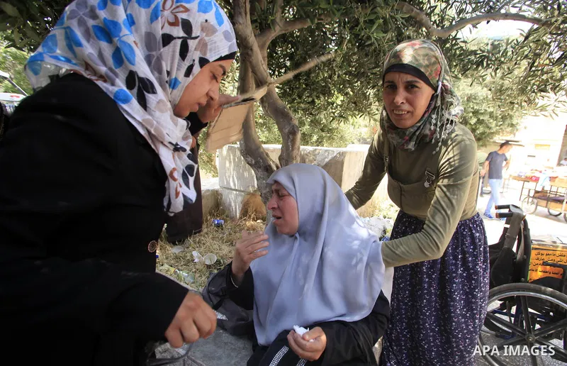 A Palestinian woman reacts after Israeli forces sprayed pepper gas at people gathering at one of the entrances to the al-Aqsa mosque compound on May 7, 2013 as police restricted the number of people entering the Muslim h...