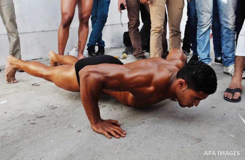 A Palestinian poses during a Gaza bodybuilding championship, on May 10, 2013, in Gaza city. Photo by Mohammed Nehru