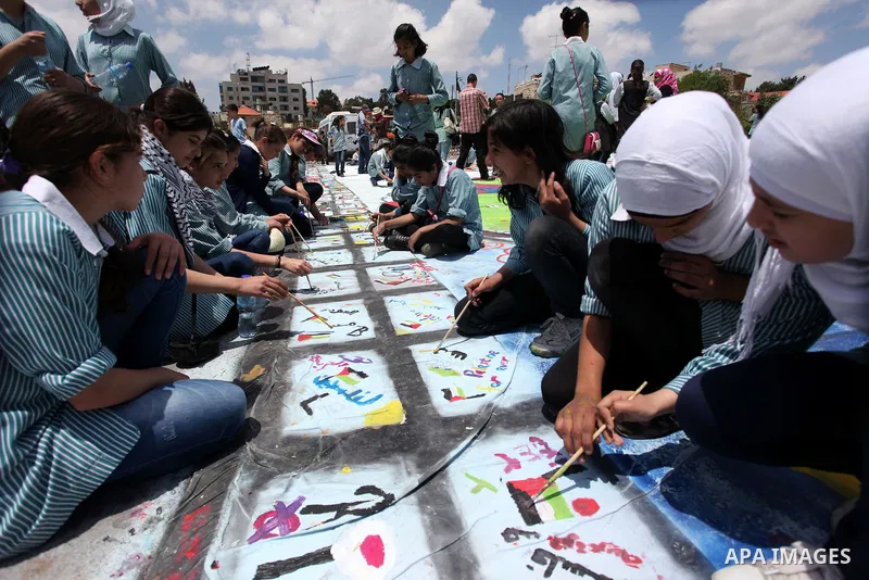 Palestinian students draw paintings to commemorate Nakba Day in the West Bank city of Ramallah in May 14, 2013. Palestinians are preparing to mark Nakba Day on May 15 which commemorates the exodus of hundreds of thousand...
