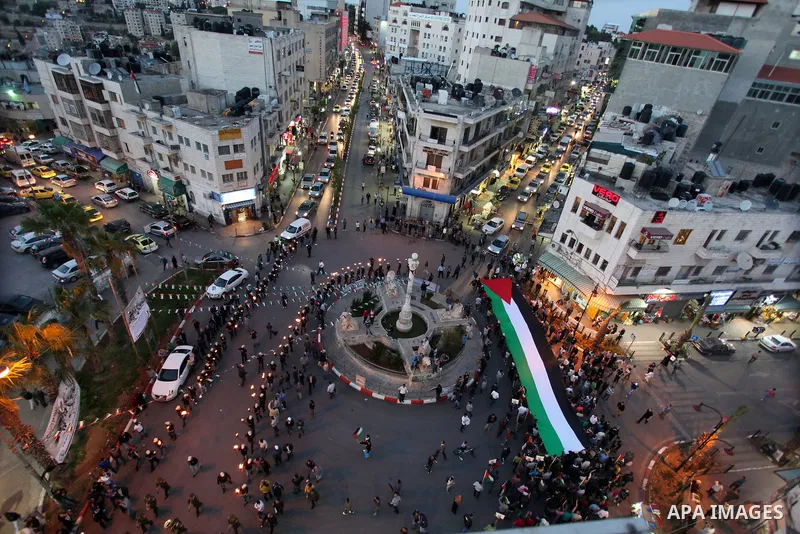 Palestinian protestors hold up torches during a rally to mark the beginning of the Nakba or the ''Day of Catastrophe'', in the old city of Ramallah on May 14, 2013. Palestinians will mark the 65th Nakba as a day of mourn...