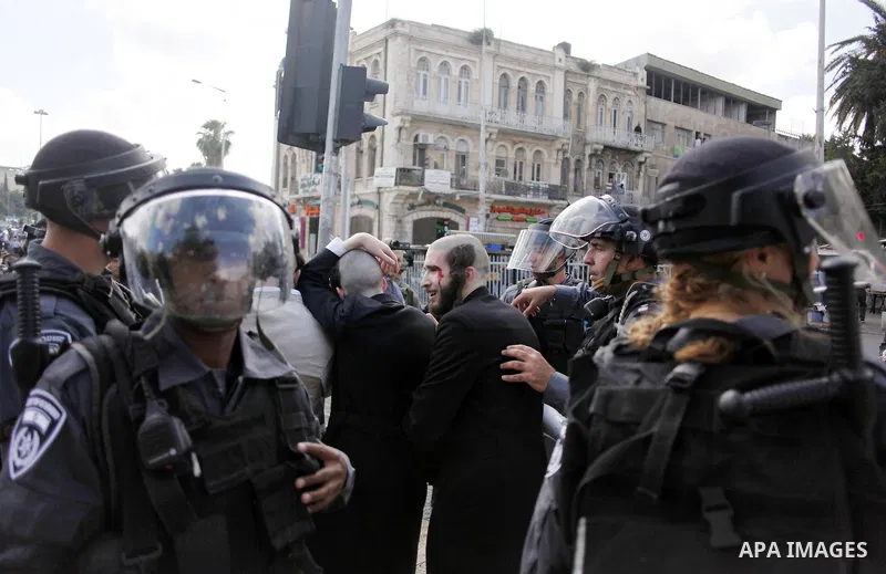 An ultra-Orthodox Jewish man bleeds after he was hit by a stone during clashes that erupted during a rally marking the Nakba or the "Day of Catastrophe" commemorations in Jerusalem, on May 15, 2013. Palestinians commemor...