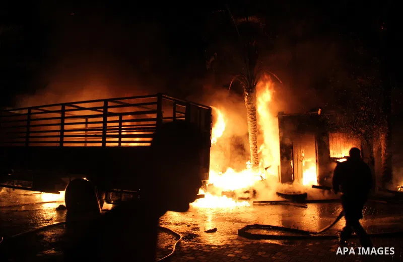 Palestinian firemen try to extinguish a fire at a livestock farm in Rafah in southern Gaza Strip on May 18, 2013. The fire sparked by electrical short circuit next to fuel barrels. Photo by Masad al-Mahmom