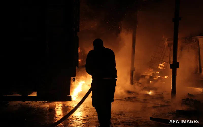 Palestinian firemen try to extinguish a fire at a livestock farm in Rafah in southern Gaza Strip on May 18, 2013. The fire sparked by electrical short circuit next to fuel barrels. Photo by Masad al-Mahmom