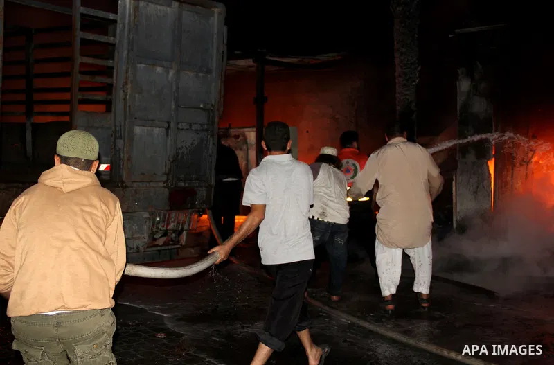 Palestinian firemen try to extinguish a fire at a livestock farm in Rafah in southern Gaza Strip on May 18, 2013. The fire sparked by electrical short circuit next to fuel barrels. Photo by Masad al-Mahmom