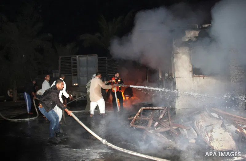 Palestinian firemen try to extinguish a fire at a livestock farm in Rafah in southern Gaza Strip on May 18, 2013. The fire sparked by electrical short circuit next to fuel barrels. Photo by Masad al-Mahmom