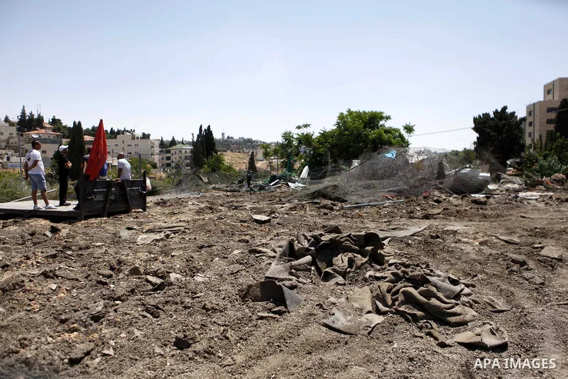 Palestinian children inspect their damaged house by the Israeli army in Shufat refugee camp in Jerusalem on May 20, 2013. Israeli bulldozers demolished a car dealership in the Sheikh Jarrah neighborhood of Jerusalem and...