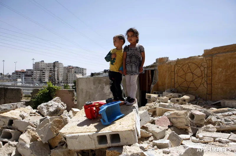 Palestinian children inspect their damaged house by the Israeli army in Shufat refugee camp in Jerusalem on May 20, 2013. Israeli bulldozers demolished a car dealership in the Sheikh Jarrah neighborhood of Jerusalem and...
